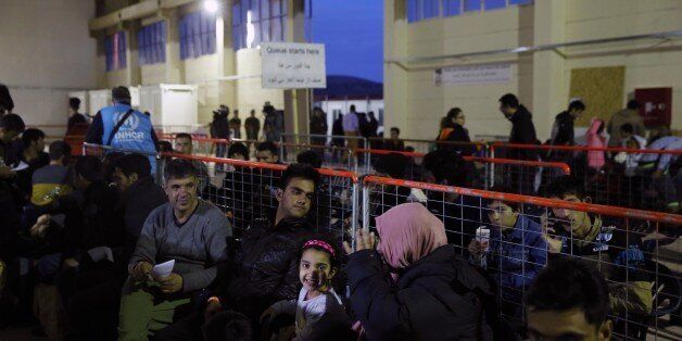 Refugees and migrants wait for the procedures at a registration and hospitality center, know as a hotspot, on the eastern Greek island of Chios, Tuesday, Feb. 16, 2016. Greek Defense Minister Panos Kammenos said that military teams have set up most of the long-delayed migrant reception facilities the country has promised its European Union partners to build. But he said the installations may not have to be fully used. (AP Photo/Petros Giannakouris)