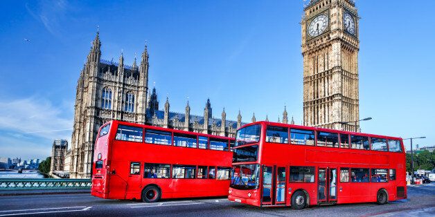 Famous Big Ben with red buses in London, England, UK
