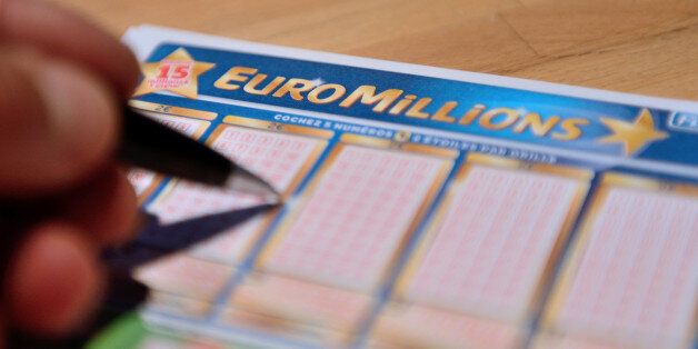 A person fills an Euro Millions lottery ticket, on June 21, 2013 in Lille, northern France. No player discovered the seven correct numbers needed to win the Euro Millions 'Super Jackpot' of 168,458.398 euros at stake on June 21, according to results released by La Francaise des Jeux. AFP PHOTO DENIS CHARLET (Photo credit should read DENIS CHARLET/AFP/Getty Images)