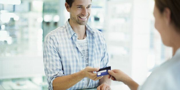 Man paying with credit card in drugstore