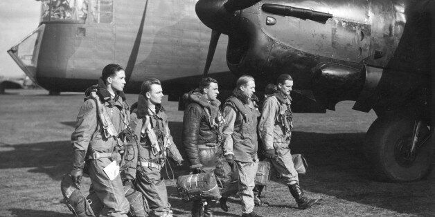 World War II British airforce bomber crew walking in front of aircraft.From left to right: Observer, Wireless Operator, Rear Gunner, Second Pilot, Pilot Captain.