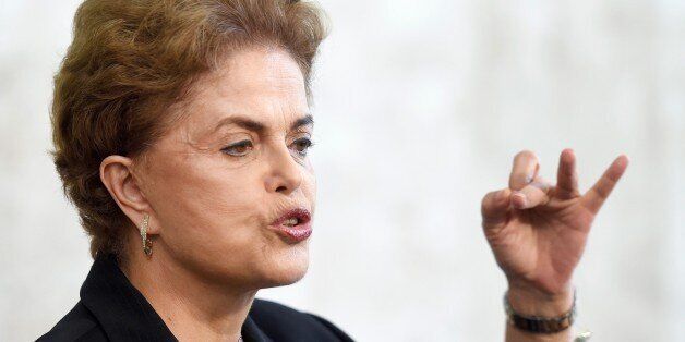 Brazilian President Dilma Rousseff holds a meeting with rectors of public universities and technical education at Planalto Palace in Brasilia, on March 11, 2016. Brazilian President Dilma Rousseff dug in Friday amid a swirling political crisis, insisting she would not resign and adamantly backing her embattled predecessor, Luiz Inacio Lula da Silva. With money-laundering charges against Lula adding to the pressure on her administration, Rousseff rejected calls to stand down, vehemently defended her mentor and said she would even be proud to have him in her cabinet -- a move that could used to protect the ex-president. Rousseff is facing an impeachment drive, a bruising recession, a massive scandal at state oil company Petrobras and a probe into alleged violations of electoral law in her reelection campaign last year. AFP PHOTO / EVARISTO SA / AFP / EVARISTO SA (Photo credit should read EVARISTO SA/AFP/Getty Images)