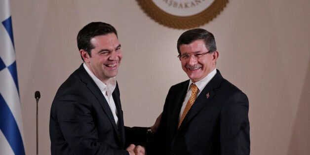 Turkey's Prime Minister Ahmet Davutoglu, right, shakes hands with Greece's Prime Minister Alexis Tsipras, following a joint news conference, after their meeting, in Izmir, Turkey, Tuesday, March 8, 2016. Turkey and Greece held holding talks on bilateral issues but also discussed the migrantsâ crisis a day after EU leaders agreed in principle on the outlines of a possible deal with Turkey for the return of thousands of migrants to Turkey. (AP Photo/Lefteris Pitarakis, Pool)