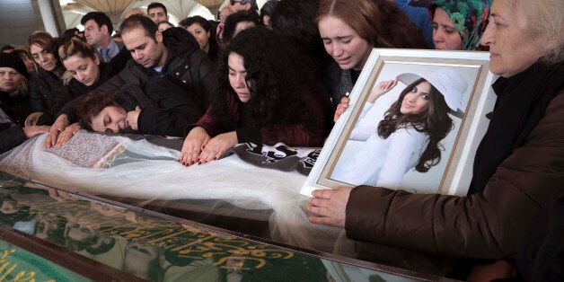 Hacer Parlak, mother of Destina Peri Parlak, 16, hugs the bridal veil-draped body of her daughter, one of the victims of Sunday's explosion, during the funeral procession in Ankara, Turkey, Tuesday, March 15, 2016. There was no immediate claim of responsibility for the Ankara attack, which authorities say was carried out by a female bomber and a possible male accomplice. Turkish Prime Minister Ahmet Davutoglu said there were