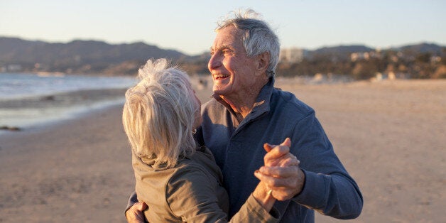 Senior Male and Female Couple Romantic Beach Lifestyle Dancing