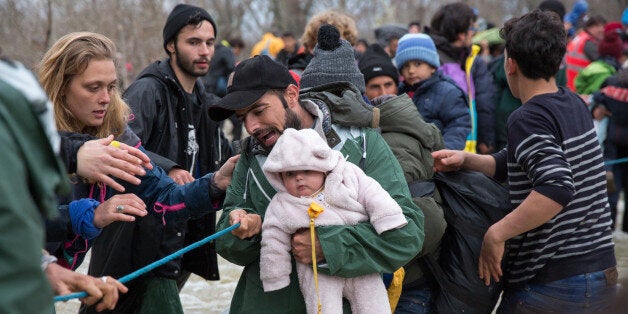 IDOMENI, GREECE - MARCH 14: Migrants try to cross a river after leaving the Idomeni refugee camp on March 13, 2016 in Idomeni, Greece. The decision by Macedonia to close its border to migrants on Wednesday has left thousands of people stranded at the Greek transit camp. The closure, following the lead taken by neighbouring countries, has effectively sealed the so-called western Balkan route, the main migration route that has been used by hundreds of thousands of migrants to reach countries in western Europe such as Germany. Humanitarian workers have described the conditions at the camp as desperate, which has been made much worse by recent bouts of heavy rain. (Photo by Matt Cardy/Getty Images)