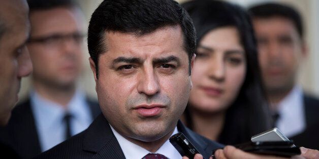 Turkish co-chairman of pro-Kurdish People's Democratic Party, or HDP, Selahattin Demirtas speaks with journalists after his meeting with Greek Prime Minister Alexis Tsipras, in Athens, on Monday, Feb. 15, 2016. (AP Photo/Petros Giannakouris)