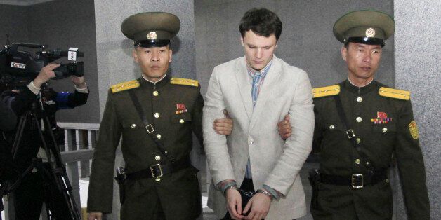 American student Otto Warmbier, center, is escorted at the Supreme Court in Pyongyang, North Korea, Wednesday, March 16, 2016. North Korea's highest court sentenced Warmbier, a 21-year-old University of Virginia undergraduate student, from Wyoming, Ohio, to 15 years in prison with hard labor on Wednesday for subversion. He allegedly attempted to steal a propaganda banner from a restricted area of his hotel at the request of an acquaintance who wanted to hang it in her church. (AP Photo/Jon Chol Jin)