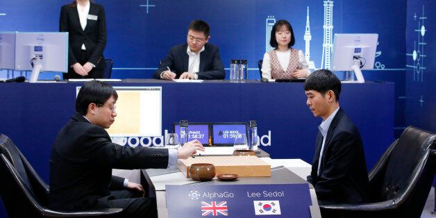 South Korean professional Go player Lee Sedol, right, watches as Google DeepMind's lead programmer Aja Huang, left, puts the Google's artificial intelligence program, AlphaGo's first stone during the final match of the Google DeepMind Challenge Match in Seoul, South Korea, Tuesday, March 15, 2016. A champion Go player scored his first win over a Go-playing computer program on Sunday after losing three straight times in the ancient Chinese board game, saying he finally found weaknesses in the software. (AP Photo/Lee Jin-man)