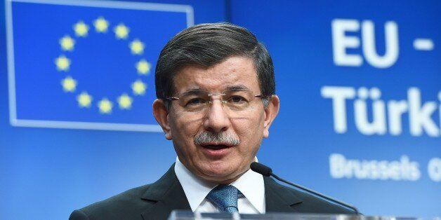 Turkey's Prime Minister Ahmet Davutoglu addresses a press conference at the end of an EU leaders summit with Turkey centered on the the migrants crisis, at the European Council, in Brussels on March 8, 2016. European Union leaders will on March 7 back closing down the Balkans route used by most migrants to reach Europe, diplomats said, after at least 25 more people drowned trying to cross the Aegean Sea en route to Greece. The declaration drafted by EU ambassadors on March 6 will be announced at a summit in Brussels on March 7, set to also be attended by Turkish Prime Minister Ahmet Davutoglu. / AFP / EMMANUEL DUNAND (Photo credit should read EMMANUEL DUNAND/AFP/Getty Images)