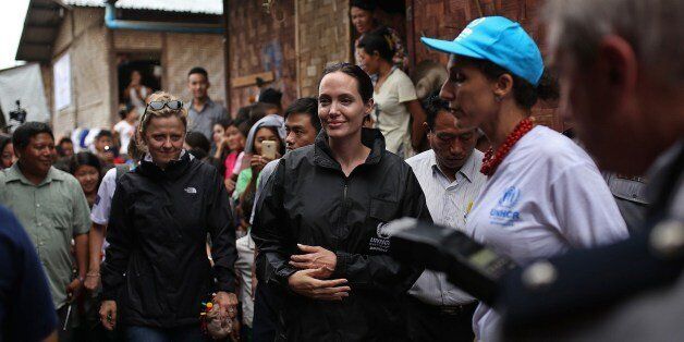 US actress and UNHCR Goodwill Ambassador Angelina Jolie (C) visits Jan Mai Kaung refugee camp in Myitkyina, Kachin State in Myanmar on July 30, 2015. Jolie flew into Myanmar for a humanitarian visit, becoming the latest in a growing list of celebrities who have travelled to the former junta-run nation. AFP PHOTO / Hkun Latt (Photo credit should read HKUN LATT/AFP/Getty Images)
