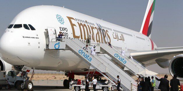Visitors look at an Emirates airline's Airbus A380 dislayed at the Dubai Airshow on November 9, 2015. AFP PHOTO / MARWAN NAAMANI (Photo credit should read MARWAN NAAMANI/AFP/Getty Images)