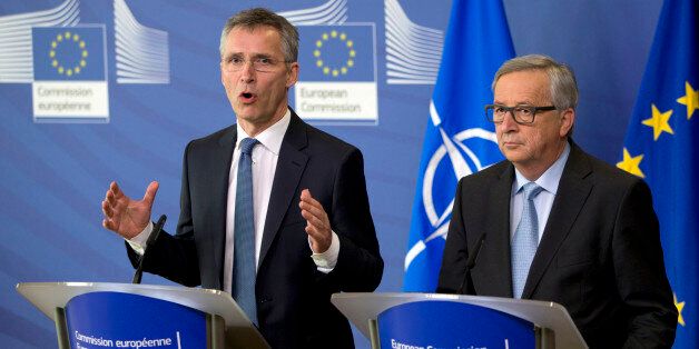 NATO Secretary General Jens Stoltenberg, left, participates in a media conference with European Commission President Jean-Claude Juncker at EU headquarters in Brussels on Thursday, March 10, 2016. NATO Secretary General Jens Stoltenberg visited EU headquarters on Thursday to discuss the current migration crisis.(AP Photo/Virginia Mayo)