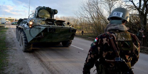 Hungarian soldiers control with their armoured car the metal fence-saved border line at Asotthalom border station of the Hungarian-Serbian border on February 24, 2016.Hungary reported a sharp rise in the numbers of migrants breaching its southern borders in February, the first significant surge since the frontiers were sealed last year. / AFP / Csaba SEGESVARI (Photo credit should read CSABA SEGESVARI/AFP/Getty Images)