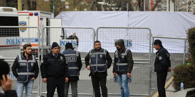 Police officers stand guard at the security perimeter around the scene of an explosion on March 14, 2016 the day after a suicide car bomb ripped through a busy square in central Ankara killing at least 34 people and wounding 125, officials said, the latest in a spate of deadly attacks to hit Turkey.The explosion at 6:45 pm (1645 GMT) struck a bus stop near Kizilay square, a bustling commercial area and local transport hub, reducing buses to charred husks and damaging nearby shops. Officials said the blast was caused by a vehicle packed with explosives, which the interior minister said was driven by one or two attackers who had deliberately targeted the bus stop. / AFP / ADEM ALTAN (Photo credit should read ADEM ALTAN/AFP/Getty Images)