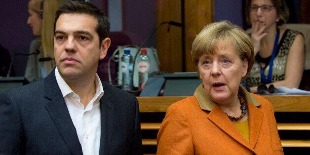 German Chancellor Angela Merkel, right, and Greek Prime Minister Alexis Tsipras arrive for a round table meeting during an EU summit at EU headquarters in Brussels on Sunday, Oct. 25, 2015. EU leaders meet on Sunday to discuss refugee flows along the Western Balkans route. (AP Photo/Virginia Mayo)