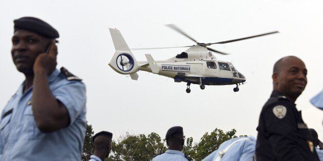 A helicopter handed over by the national council of security hovers over Ivorian policemen at the police academy in Abidjan on December 23, 2014 within the framework of modernising Ivory Coast's national police force. AFP PHOTO/SIA KAMBOU (Photo credit should read SIA KAMBOU/AFP/Getty Images)