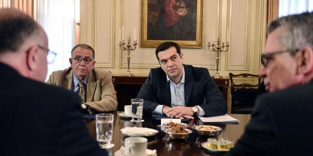 Greek Prime Minister Alexis Tsipras (C) and Greek Junior Interior Minister for Migration Ioannis Mouzalas (C-L) meet with Interior Ministers of Germany, Thomas de Maiziere (R) and of France, Bernard Cazeneuve, at prime minister's office in Athens, on February 5, 2016. The ministers met for talks focusing on migration crisis. / AFP / LOUISA GOULIAMAKI (Photo credit should read LOUISA GOULIAMAKI/AFP/Getty Images)