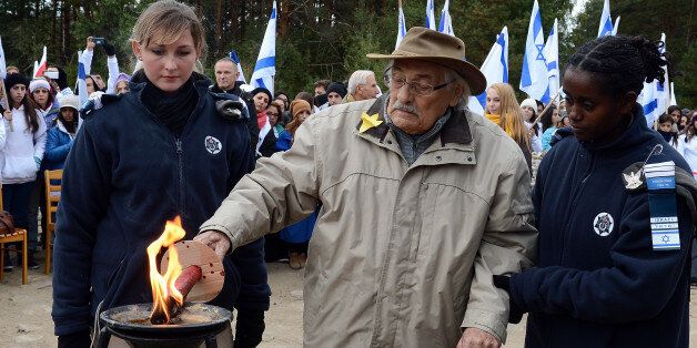 Samuel Willenberg (C), the only living survivor of an August 1943 prisoner rebellion at Treblinka lights a candle in front of the monument of Treblinka World War II-era Nazi death camp on October 2, 2013 in Treblinka. Around 600 young Israelis and Poles participated in a memorial ceremony at the site of the Treblinka WWII-era Nazi death camp, east of the Polish capital Warsaw. Samuel Willenberg, the only living survivor of an August 1943 prisoner rebellion at Treblinka also attended along with several Poles recognized by Israel as righteous gentiles for risking their lives to save Jews from Nazi German genocide. AFP PHOTO/JANEK SKARZYNSKI (Photo credit should read JANEK SKARZYNSKI/AFP/Getty Images)