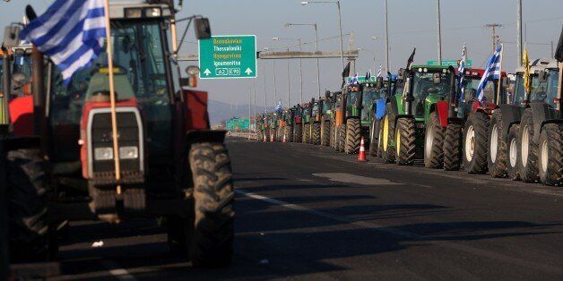 Tractors are parked at the border crossing of Kipoi between Greece and Turkey, northeastern Greece, as farmers set up a blockade at customs offices, shutting down movement of trucks to and from Turkey on February 2, 2016, protesting against a controversial pension reform.Greece and its creditors on February 1 began a first review of the country's new bailout amid a wave of demonstrations by farmers and professionals against a controversial pension reform that is part of the fiscal overhaul. / AFP / SAKIS MITROLIDIS (Photo credit should read SAKIS MITROLIDIS/AFP/Getty Images)