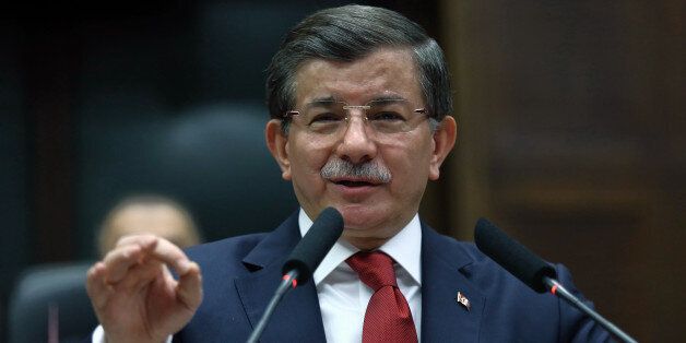 Turkish Prime Minister Ahmet Davutoglu addresses his lawmakers in Ankara, Turkey, Tuesday, Feb. 16, 2016. Turkish artillery continue to pound the positions in northern Syria as a Turkish official says his country is pushing the case for ground operations in Syria, hoping for the involvement of the U.S. and other allies in an international coalition against the Islamic State group.The official told reporters in Istanbul that