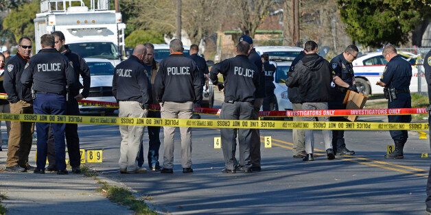 Officers investigate the scene of a shooting in Baton Rouge, La., Saturday, Feb. 13, 2016. Police officers who were shot early Saturday during a confrontation with a suspect were responding to a call about someone damaging property. (AP Photo/Bill Feig)