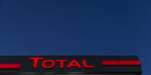 A Total logo sits illuminated above the forecourt of a gas station operated by Total SA in Luc-La-Primaube near Rodez, France, on Friday, Dec. 11, 2015. Oil extended declines from the lowest price since February 2009 as Iran pledged to boost crude exports, bolstering speculation OPEC members will exacerbate the global oversupply. Photographer: Balint Porneczi/Bloomberg via Getty Images
