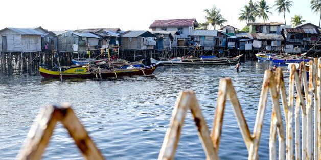 Boats are moored in front of houses on stilts in the Isla Verde shantytown of Davao, Mindanao, the Philippines, on Friday, Dec. 11, 2015. Davao city's reputation as one of the safest, most vibrant and best-run cities in the country is drawing migrants and business people in their thousands. It has become a victim of its own success, and an archetype of modern urbanization in developing countries, where inward migration is outstripping governments' ability to supply infrastructure and services. Photographer: Veejay Villafranca/Bloomberg via Getty Images