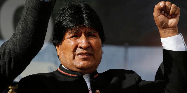 Bolivia's President Evo Morales sings his national anthem at a signing ceremony for the expansion of a road that connects the capital with the nearby city of El Alto, in La Paz, Bolivia, Monday, Feb. 22, 2016, one day after a referendum on expanding presidential term limits. Partial results Monday and unofficial