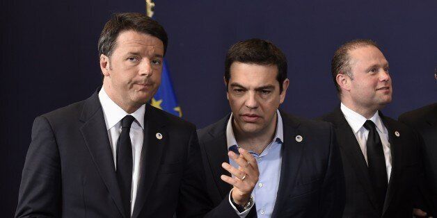 (LtoR) Italian Prime minister Matteo Renzi talks with Greek Prime Minister Alexis Tsipras (C) as Maltese Prime Minister Joseph Muscat (Back) stands along side for a family photo during a European Union summit at the EU headquarters in Brussels on April 23, 2015. Rights group Amnesty urged European leaders to launch a humanitarian operation to end the 'spiralling tragedy' of the Mediterranean migrant shipwrecks on the eve of an emergency Brussels summit. AFP PHOTO JOHN THYS (Photo credit should read JOHN THYS/AFP/Getty Images)