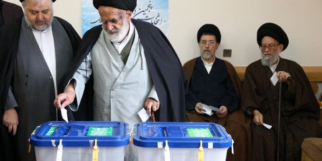 Iranian clergymen vote in the parliamentary and Experts Assembly elections at a polling station in Qom, 125 kilometers (78 miles) south of the capital Tehran, Iran, Friday, Feb. 26, 2016. Iranians across the Islamic Republic voted Friday in the country's first election since its landmark nuclear deal with world powers, deciding whether to further empower its moderate president or side with hard-liners long suspicious of the West. The election for Iran's parliament and a clerical body known as the Assembly of Experts hinges on both the policies of President Hassan Rouhani, as well as Iranians worries about the country's economy, long battered by international sanctions. (AP Photo/Ebrahim Noroozi)