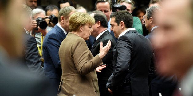 German Chancellor Angela Merkel, center left, speaks with Greek Prime Minister Alexis Tsipras, center right, during a round table meeting at an EU summit in Brussels on Thursday, Feb. 18, 2016. European Union leaders are holding a summit in Brussels on Thursday and Friday to hammer out a deal designed to keep Britain in the 28-nation bloc. (AP Photo/Geert Vanden Wijngaert)