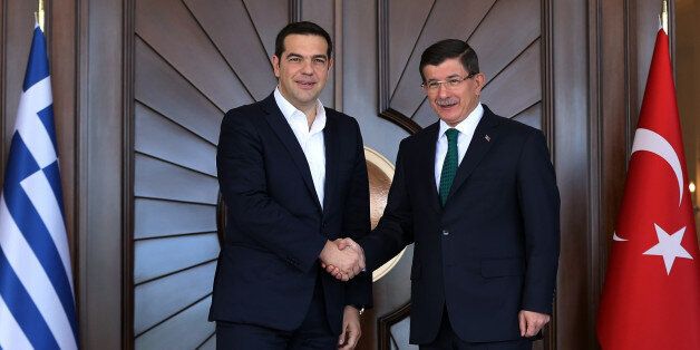 Turkey's Prime Minister Ahmet Davutoglu, right, and Greece's Prime Minister Alexis Tsipras shake hands before their talks at Cankaya Palace in Ankara, Turkey, Wednesday, Nov. 18, 2015. Tsipras is in Ankara on a one-day working visit.(AP Photo/Burhan Ozbilici)