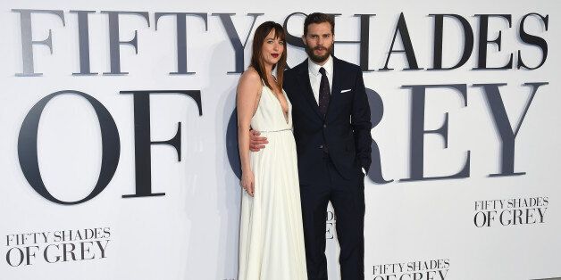 FILE - In this Feb. 12, 2015 file photo, Dakota Johnson and Jamie Dornan pose for photographers at the UK Premiere of Fifty Shades of Grey, at a central London cinema.