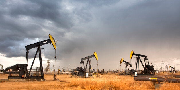 A nodding donkey pumps crude up from the ground on an oil field.