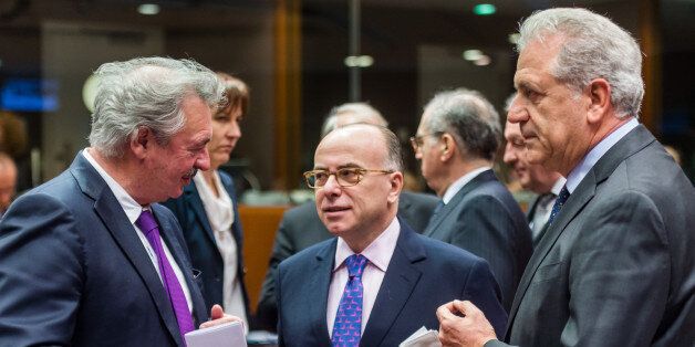 French Interior Minister Bernard Cazeneuve, center, talks with European Commissioner for Migration and Home Affairs Dimitris Avramopoulos, right, and Luxembourg's Minister of Foreign and European Affairs Jean Asselborn during an EU justice and home affairs council at the EU Council building in Brussels on Thursday, Feb. 25, 2016. (AP Photo/Geert Vanden Wijngaert)