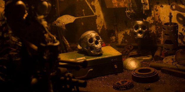 Simulated skulls rest on a table display in a viewing area at the USS Nightmare Halloween attraction on the banks of the Ohio River, Sunday, Oct. 25, 2015, in Newport, Ky. The barge, retrofitted as a floating haunted house, serves the Cincinnati and northern Kentucky area. (AP Photo/John Minchillo)