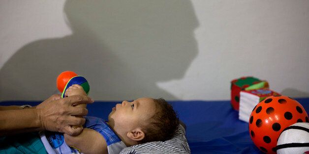 Caio Julio Vasconcelos who was born with microcephaly undergoes physical therapy at the Institute for the Blind in Joao Pessoa, Brazil, Thursday, Feb. 25, 2016. Researchers from the Centers of Disease Control and Prevention continue to fan out across one of Brazil's poorest states in search of mothers and infants for a study aimed at determining whether the Zika virus is causing babies to be born with unusually small heads. (AP Photo/Andre Penner)