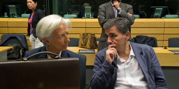 Greek Finance Minister Euclid Tsakalotos, right, speaks with Managing Director of the International Monetary Fund Christine Lagarde during a round table meeting of eurogroup finance ministers at the EU Lex building in Brussels on Sunday, July 12, 2015. Greece has another chance Sunday to convince skeptical European creditors that it can be trusted to enact wide-ranging economic reforms which would safeguard its future in the common euro currency. (AP Photo/Michel Euler)