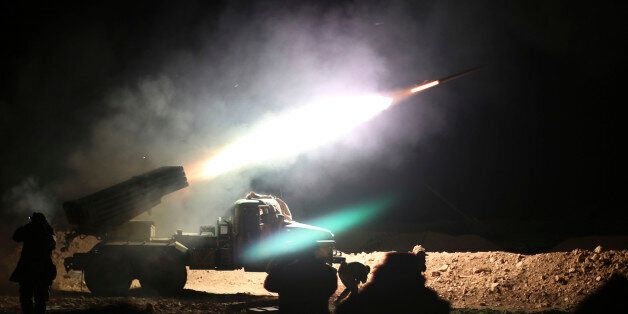 In this photo taken on Wednesday, Feb. 17, 2016, soldiers from the Syrian army fire a rocket at Islamic State group positions in the province of Raqqa, Syria. In recent weeks, Syrian government forces captured dozens of villages and towns across the country. (Alexander Kots/Komsomolskaya Pravda via AP)