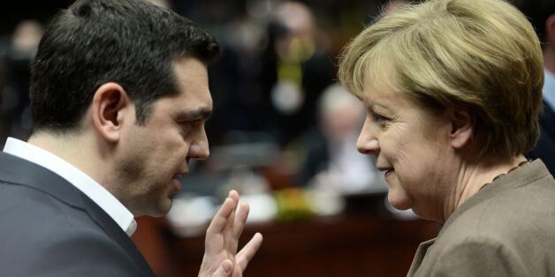 Greece's Prime Minister Alexis Tsipras (L) talks with German Chancellor Angela Merkel during an EU summit meeting, at the European Union council in Brussels, on February 18, 2016. EU leaders head into a make-or-break summit sharply divided over difficult compromises needed to avoid Britain becoming the first country to crash out of the bloc. / AFP / STEPHANE DE SAKUTIN (Photo credit should read STEPHANE DE SAKUTIN/AFP/Getty Images)