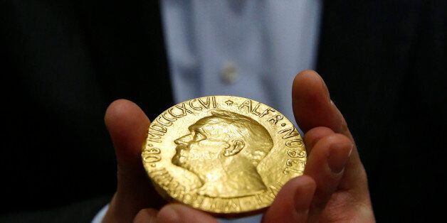 Bidder Ole Bjorn Fausa, of Norway, holds the 1936 Nobel Peace Prize medal in Baltimore, Thursday, March 27, 2014, the second Nobel Peace Prize ever to come to auction. The prize sold for a winning bid of $950,000 at auction, and an additional buyerâs commission brought the final sale price to $1.16 million. The recipient was Argentina's foreign minister, Carlos Saavedra Lamas, who was honored for his role in negotiating the end of the Chaco War between Paraguay and Bolivia. (AP Photo/Patrick Semansky)