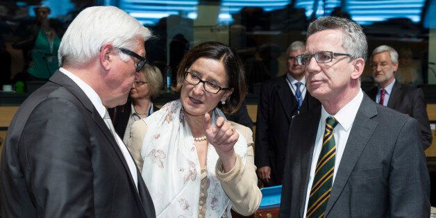 German Foreign Minister Frank-Walter Steinmeier, left, speaks with Austrian Justice Minister Johanna Mikl-Leitner, center, and German Justice Minister Thomas de Maiziere during a meeting of EU foreign ministers at the EU Council building in Luxembourg on Monday, April 20, 2015. An Italian coast guard ship headed toward Sicily Monday to look for survivors of a capsized ship in what could be the Mediterranean's deadliest migrant tragedy, as EU foreign ministers gathered for an emergency meeting to discuss the crisis. (AP Photo/Thierry Monasse)