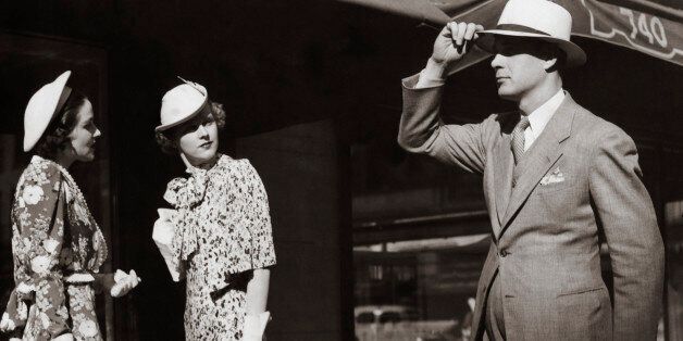Gentleman tipping hat to ladies