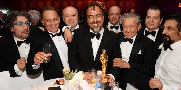 Alejandro G. Inarritu, center, winner of the award for best director for âThe Revenantâ, and guests attend the Governors Ball after the Oscars on Sunday, Feb. 28, 2016, at the Dolby Theatre in Los Angeles. (Photo by Al Powers/Invision/AP)