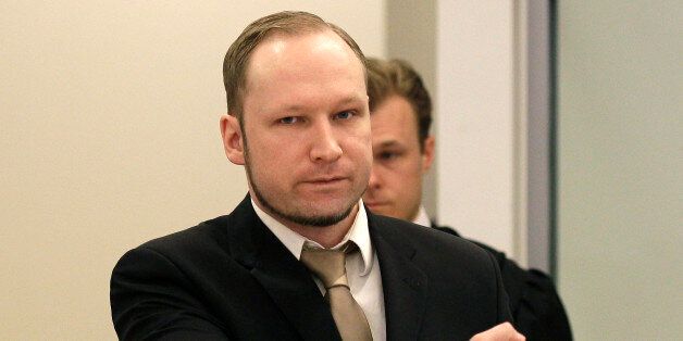Accused Norwegian Anders Behring Breivik gestures as he arrives at the courtroom, in Oslo, Norway, Tuesday April 17, 2012. The anti-Muslim fanatic who admitted to killing 77 people in a bomb-and-shooting massacre is set to take the stand in his terror trial. Anders Behring Breivik will have five days to explain why he set off a bomb in Oslo's government district, killing eight, and then gunned down 69 at a Labor Party youth camp outside the Norwegian capital. (AP Photo/Frank Augstein)