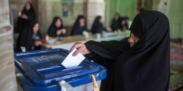 TEHRAN, IRAN - FEBRUARY 26: An Iranian woman votes in the parliamentary and Experts Assembly elections at a polling station in Qom, 125 kilometers (78 miles) south of the capital Tehran, Iran, Friday, Feb. 26, 2016. Iranians were voting on Friday in parliamentary elections, the country's first since its landmark nuclear deal with world powers last summer