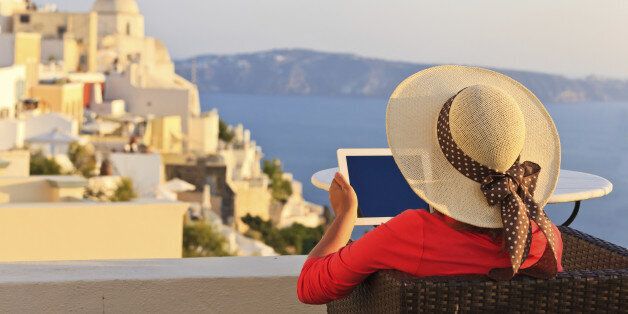 woman with touch pad in Santorini, travel concept