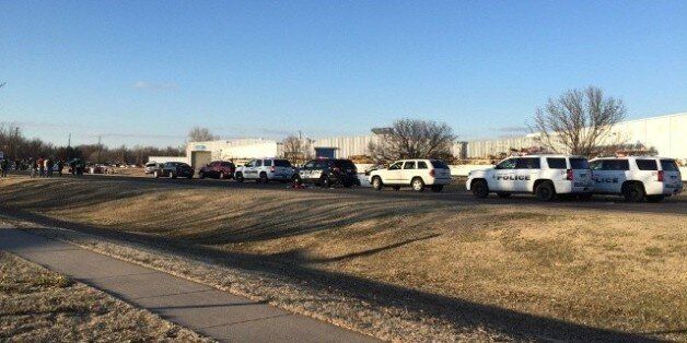In this photo provided by KWCH-TV, police vehicles line the road after reports of a shooting in Hesston, Kan., Thursday, Feb. 25, 2016. A Harvey County sheriff's dispatcher said the shooting occurred Thursday afternoon at Excel Industries. (KWCH-TV via AP) MANDATORY CREDIT