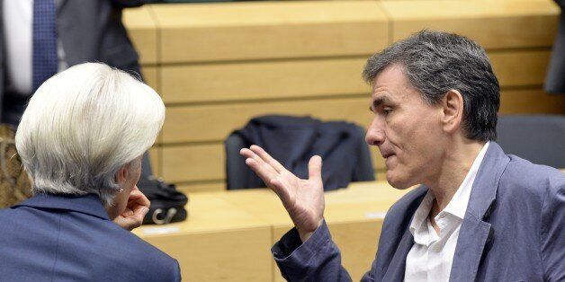 Greek Finance Minister Euclid Tsakalotos (R) gestures as he speaks with Managing Director of the International Monetary Fund (IMF) Christine Lagarde during a meeting of the Eurogroup finance ministers in Brussels on July 12, 2015. The EU cancelled a full 28-nation summit today to decide Greece's fate in the single European currency, although a meeting of leaders from the 19 countries in the eurozone will go ahead as planned. AFP PHOTO / THIERRY CHARLIER (Photo credit should read THIERRY CHARLIER/AFP/Getty Images)
